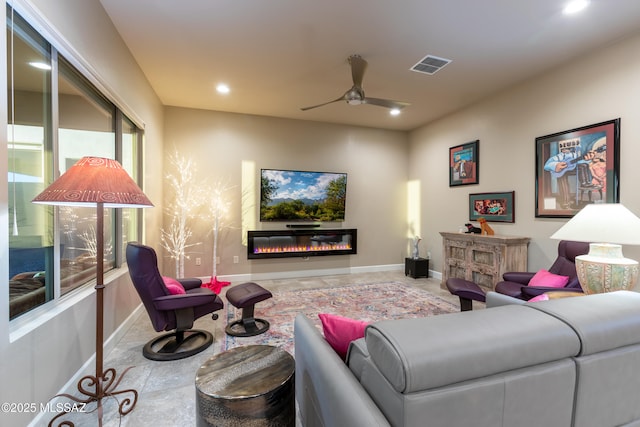 living room featuring plenty of natural light and ceiling fan