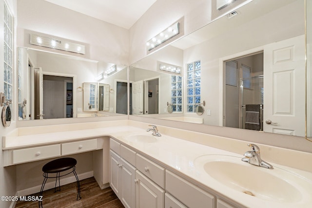 bathroom with vanity, hardwood / wood-style floors, and walk in shower