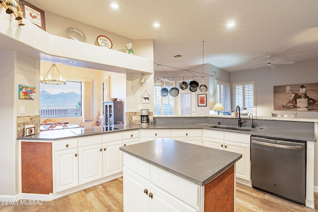 kitchen with sink, white cabinetry, kitchen peninsula, dishwasher, and black electric stovetop