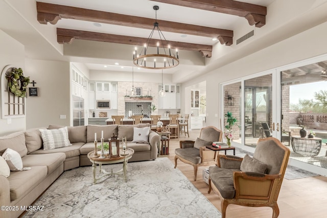 living room with an inviting chandelier and beam ceiling