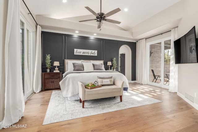 bedroom featuring ceiling fan, access to exterior, lofted ceiling, and light hardwood / wood-style floors