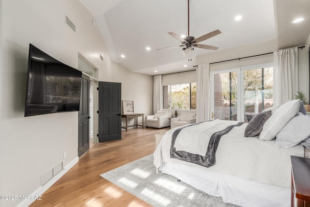 bedroom featuring ceiling fan, light hardwood / wood-style flooring, and lofted ceiling