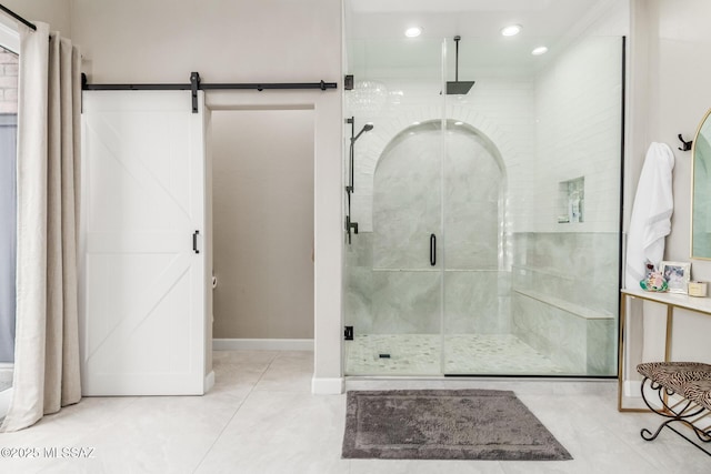 bathroom with a shower with shower door and tile patterned floors