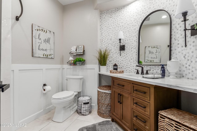 bathroom featuring tile patterned floors, vanity, and toilet