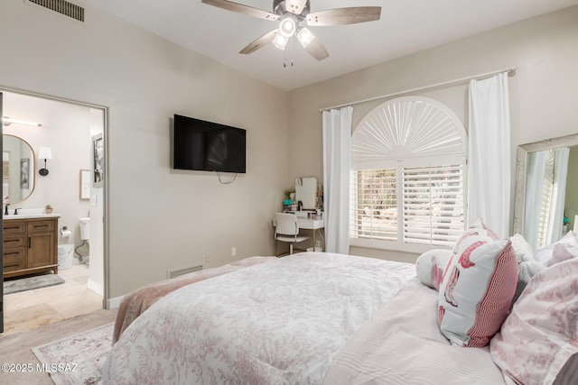 tiled bedroom with ceiling fan and ensuite bathroom