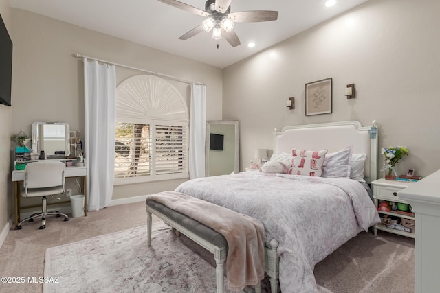 carpeted bedroom featuring lofted ceiling and ceiling fan