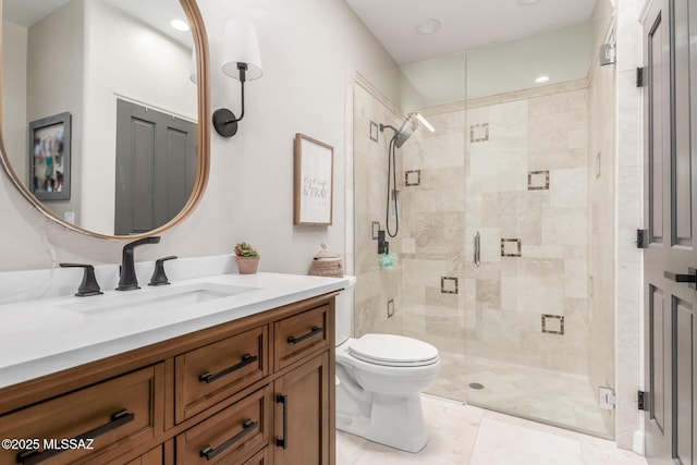 bathroom featuring toilet, an enclosed shower, and vanity