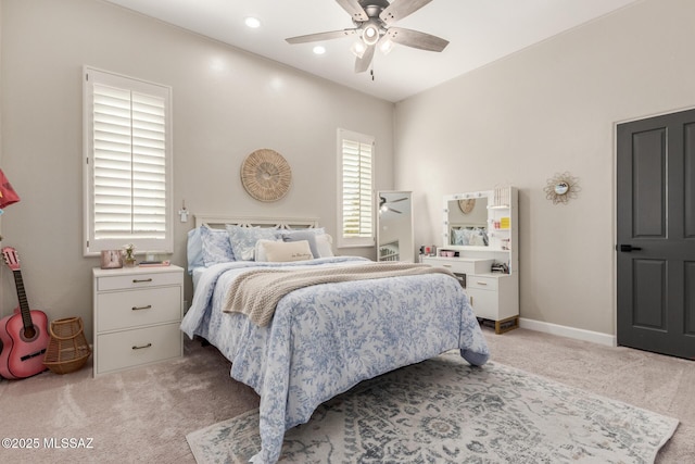 bedroom with ceiling fan and light carpet