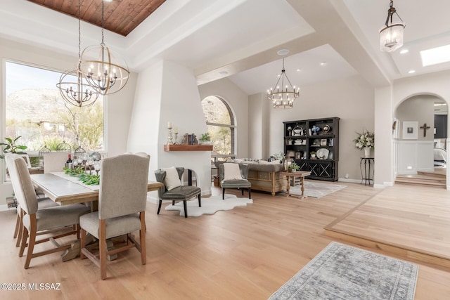 dining space with light wood-type flooring and a chandelier