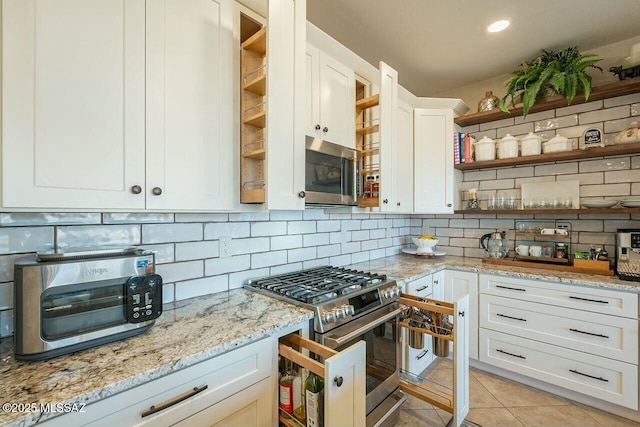 kitchen featuring light tile patterned floors, decorative backsplash, appliances with stainless steel finishes, and open shelves