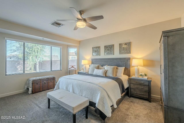 bedroom with a ceiling fan, baseboards, light colored carpet, and visible vents