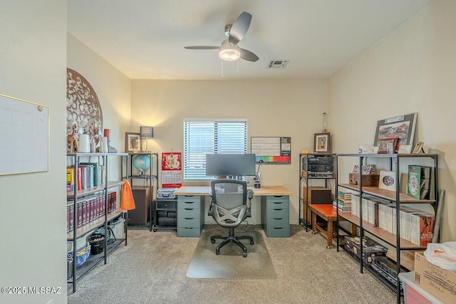 carpeted office featuring visible vents and ceiling fan
