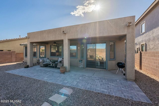 back of house featuring a fenced backyard, stucco siding, outdoor lounge area, and a patio area