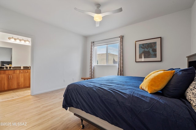 bedroom with ensuite bathroom, sink, ceiling fan, and light wood-type flooring