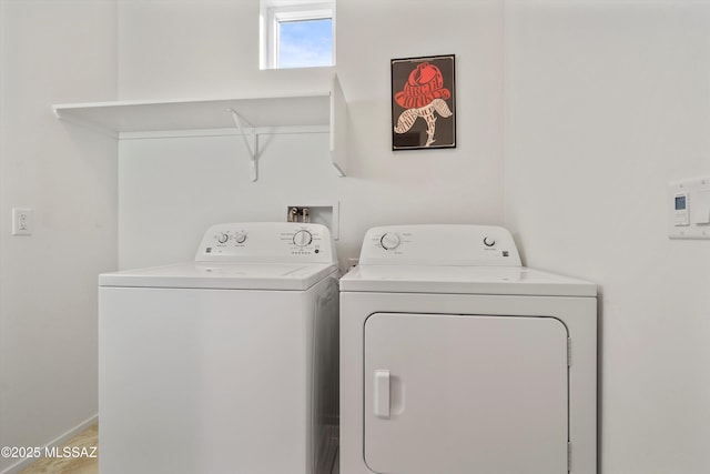 clothes washing area with washing machine and dryer