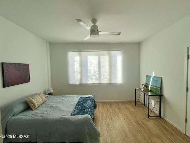 bedroom with light hardwood / wood-style flooring and ceiling fan