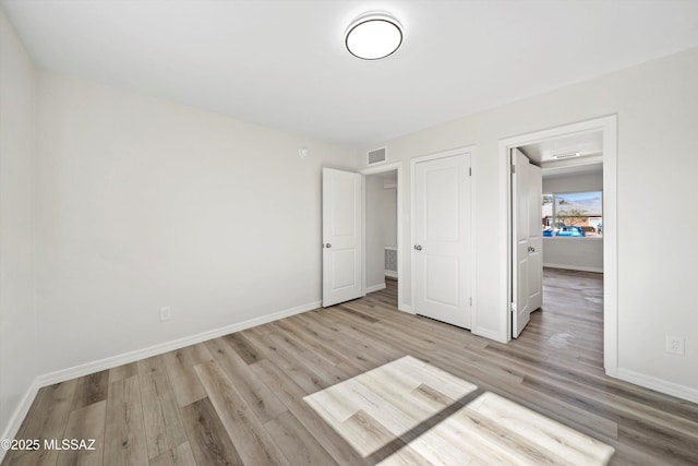 unfurnished bedroom with light hardwood / wood-style flooring