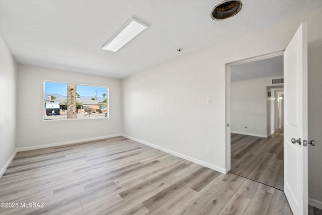 unfurnished room with light wood-type flooring