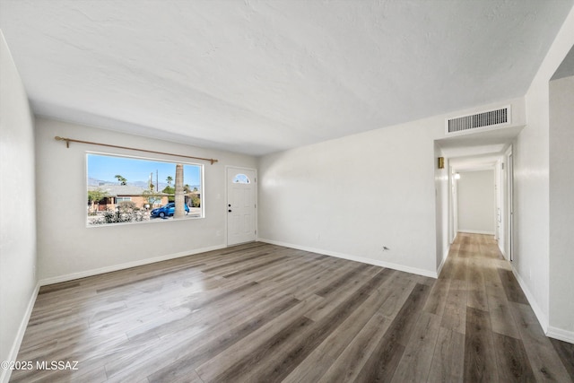 spare room with wood-type flooring