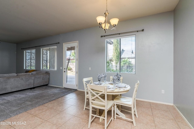 tiled dining area with a chandelier