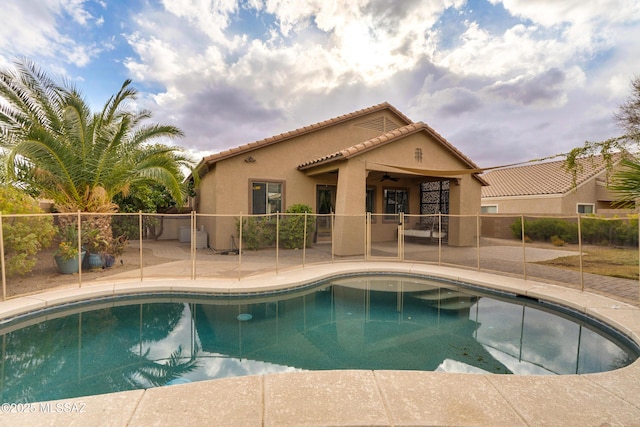 view of swimming pool featuring a patio area and ceiling fan