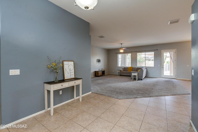 carpeted living room featuring ceiling fan