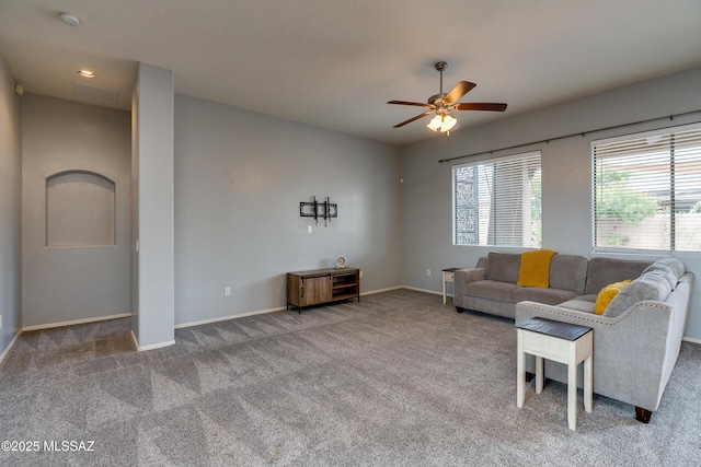 unfurnished living room featuring carpet floors and ceiling fan