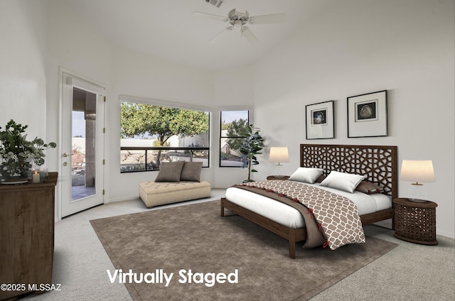 bedroom with ceiling fan, a towering ceiling, access to exterior, and carpet floors