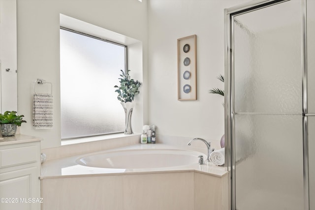 bathroom with vanity and independent shower and bath