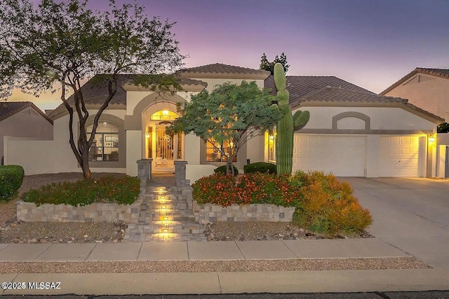 mediterranean / spanish-style house with a garage