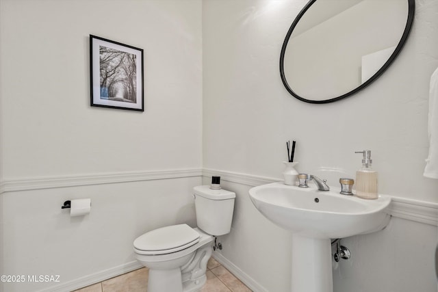 bathroom with tile patterned floors and toilet