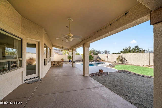 view of patio featuring ceiling fan and a fenced in pool