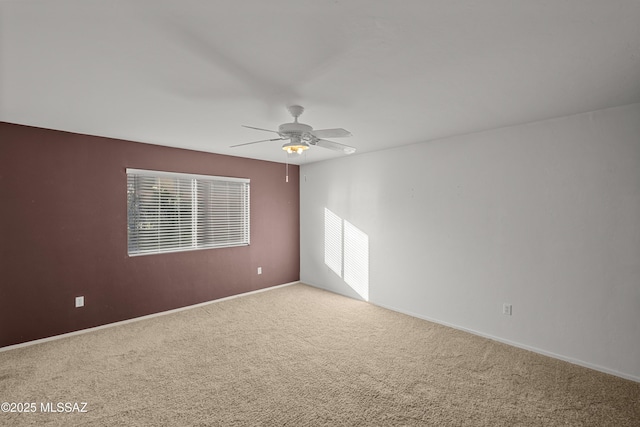 unfurnished room featuring ceiling fan and carpet floors