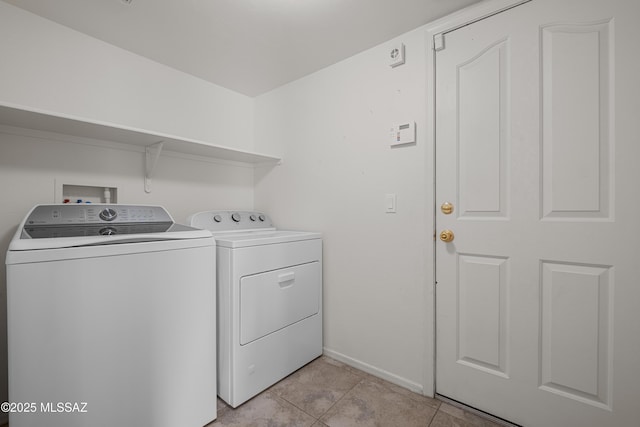 laundry room with washer and clothes dryer and light tile patterned flooring