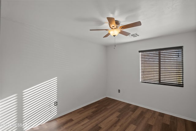 spare room with ceiling fan and dark hardwood / wood-style floors