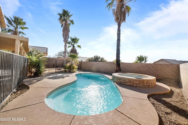 view of swimming pool with an in ground hot tub