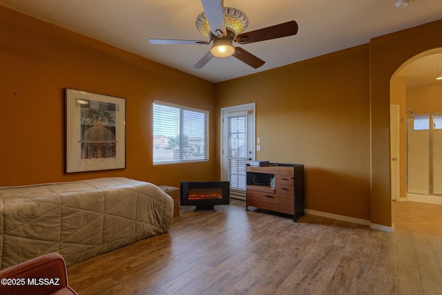 bedroom with wood-type flooring and ceiling fan