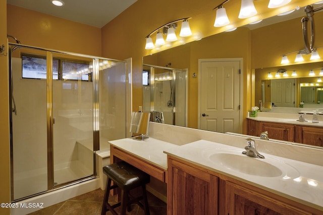 bathroom with vanity, tile patterned floors, and a shower with door