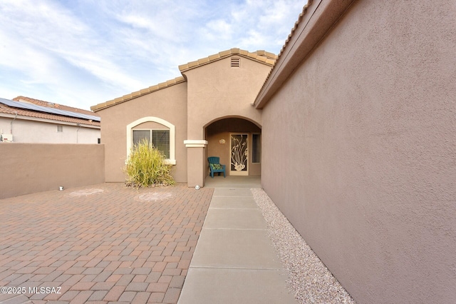 entrance to property with a patio area