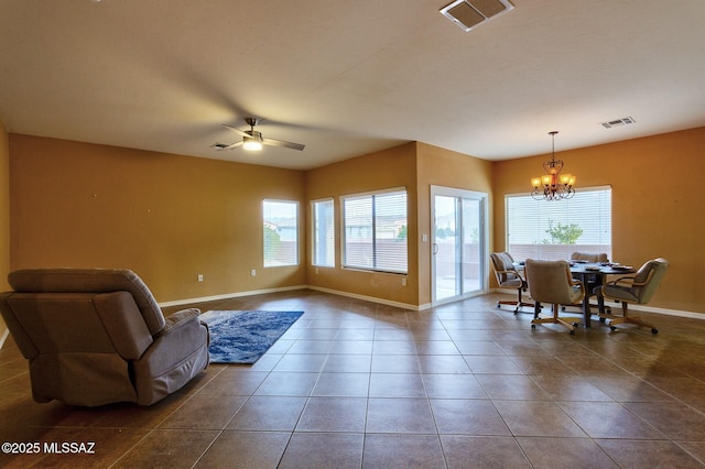 tiled living room with plenty of natural light and ceiling fan with notable chandelier