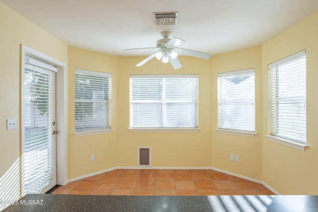 unfurnished room featuring light tile patterned floors and ceiling fan