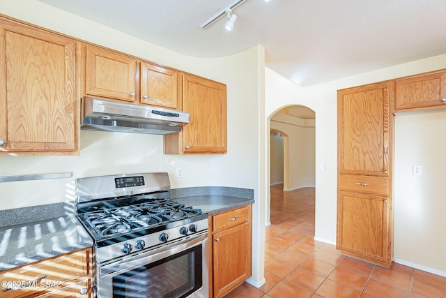 kitchen featuring stainless steel gas stove and light tile patterned floors