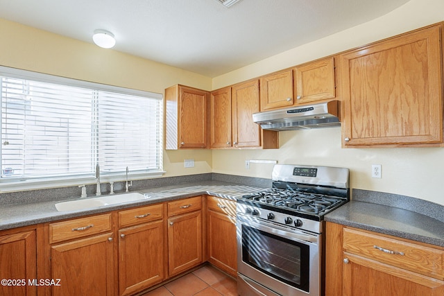 kitchen with sink, stainless steel range with gas stovetop, and light tile patterned floors