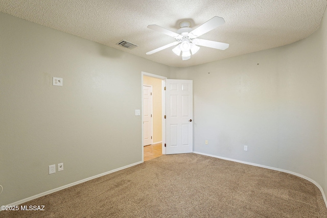 empty room with light carpet, a textured ceiling, and ceiling fan