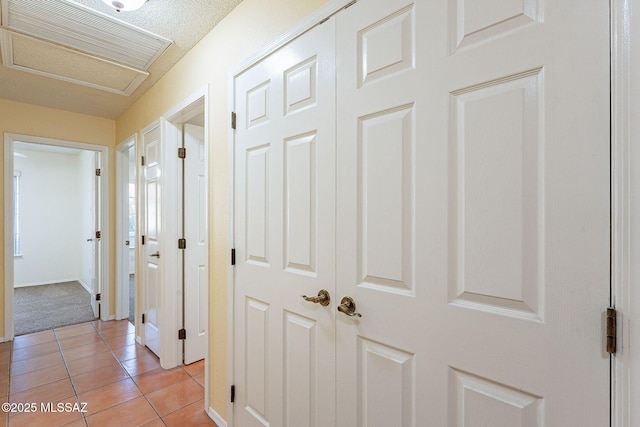 hall with light tile patterned floors