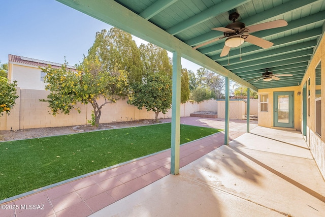 view of patio with ceiling fan and a shed