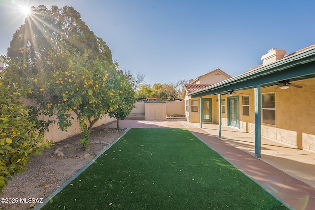 view of yard with a patio area and ceiling fan