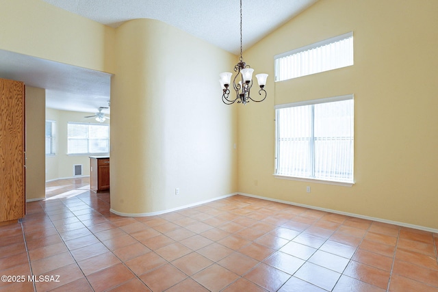 tiled spare room with lofted ceiling, ceiling fan with notable chandelier, and a textured ceiling