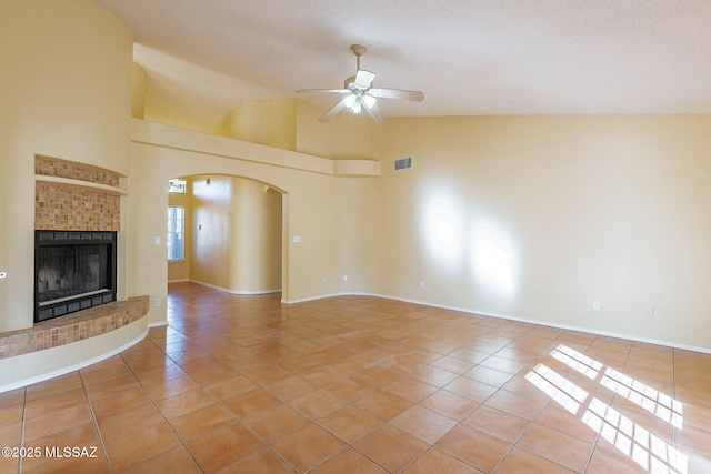 unfurnished living room with a textured ceiling, ceiling fan, and light tile patterned flooring