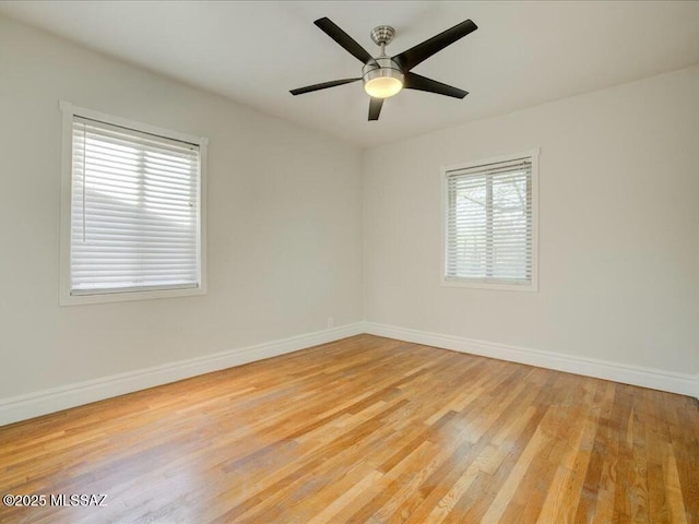 unfurnished room with light hardwood / wood-style floors, a wealth of natural light, and ceiling fan